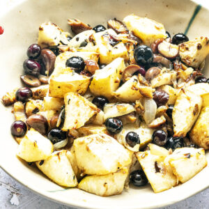 roasted celeriac in bowl with chestnuts and blueberries