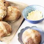 vegan hot cross buns on tray with dairy free butter in bowl