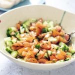 tomato and cucumber salad in ceramic bowl