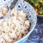 coconut sambol in bowl with curry in background