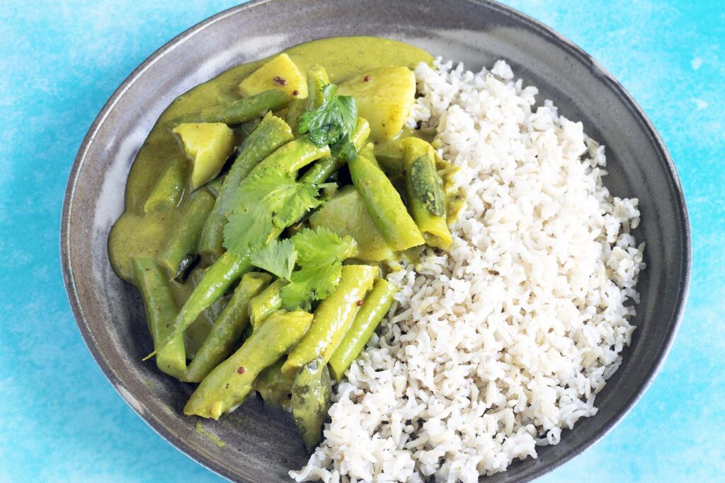 green bean curry and rice on plate