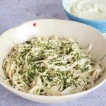 bowl of vegan cauliflower alfredo sauce with spaghetti