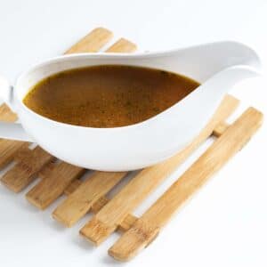 vegan gravy in white gravy boat on mat