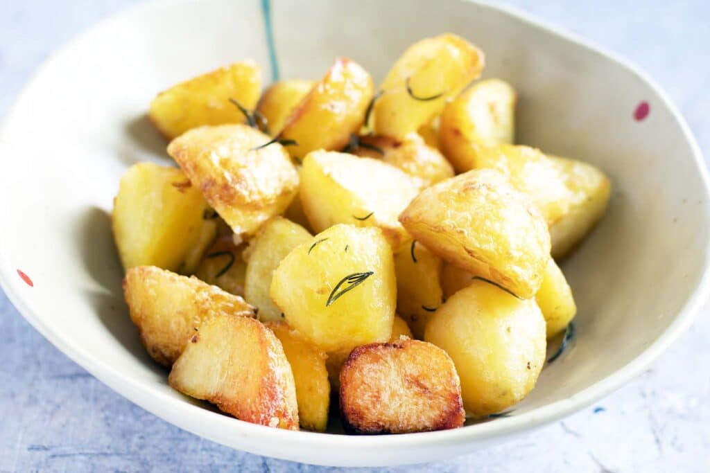 vegan roast potatoes with rosemary in bowl