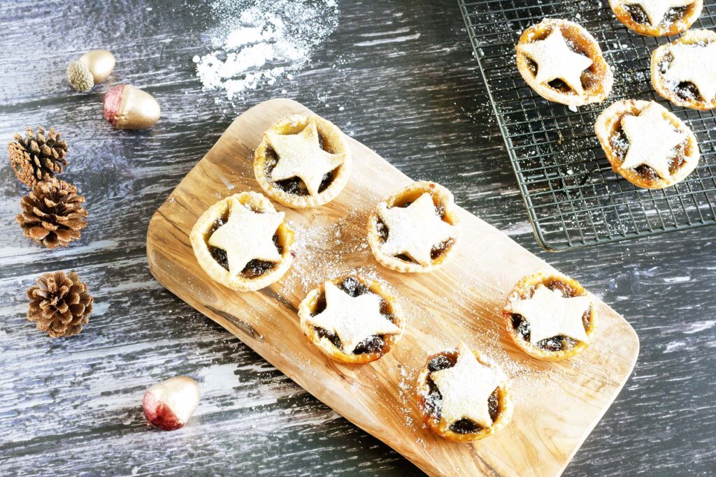 vegan mince pies with star tops on wooden board