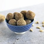 ginger energy balls in bowl with ginger and cashews