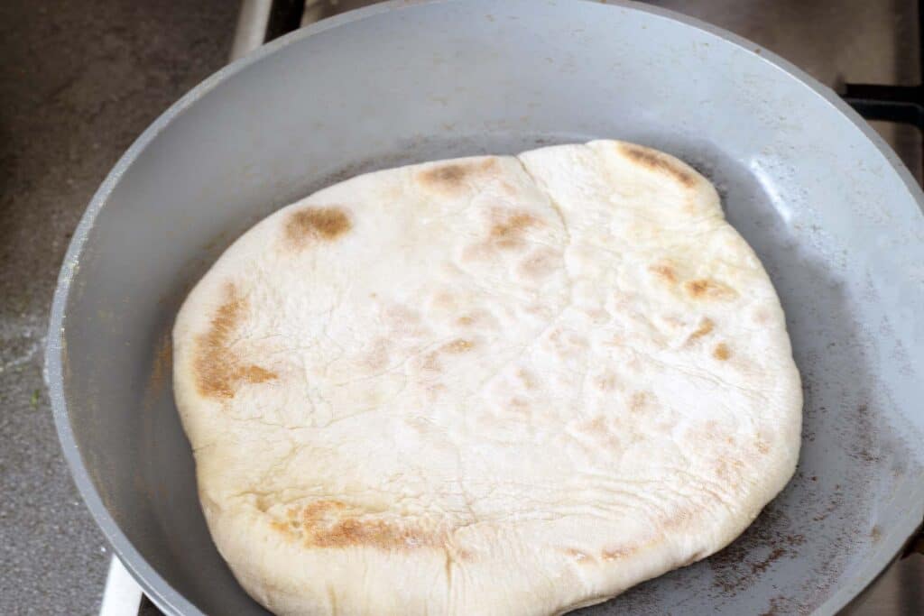 cooked flatbread on frying pan
