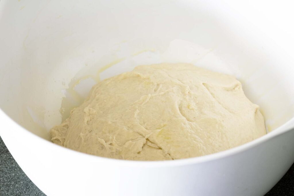 kneaded dough in white bowl