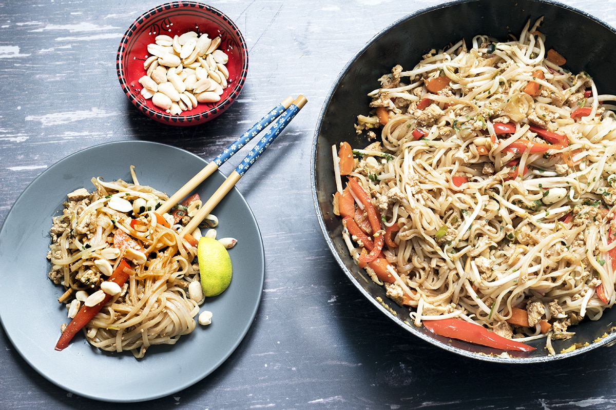 vegan pad thai in wok and on plate with chopsticks - recipe by Cook Veggielicious