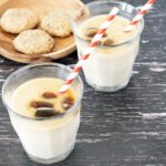 two glasses of vegan iced coffee with red and white straws