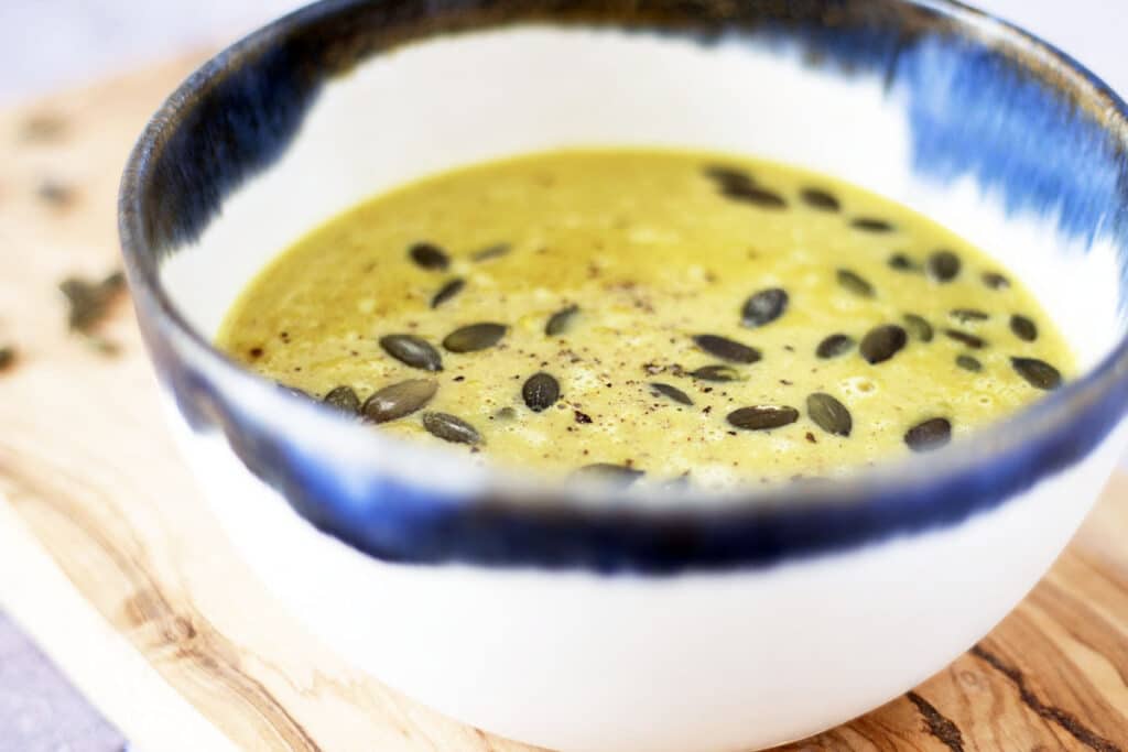 curried brussels sprouts soup in blue and white bowl