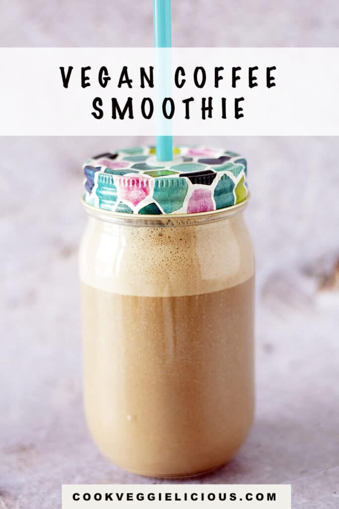 coffee smoothie in glass smoothie jar with straw on grey background