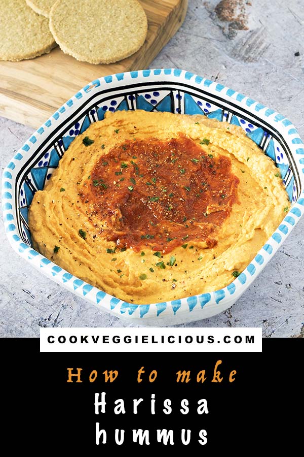 harissa hummus in blue and white bowl with crackers