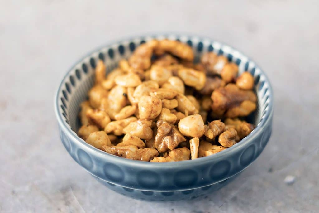 vegan spiced nuts in blue bowl by Cook Veggielicious