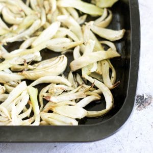 roasted fennel slices in black baking tray