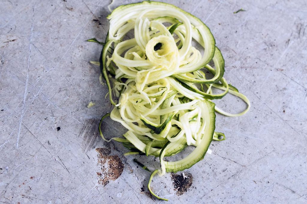 spiralised courgette on grey background