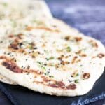 stack of vegan naan bread on slate plate