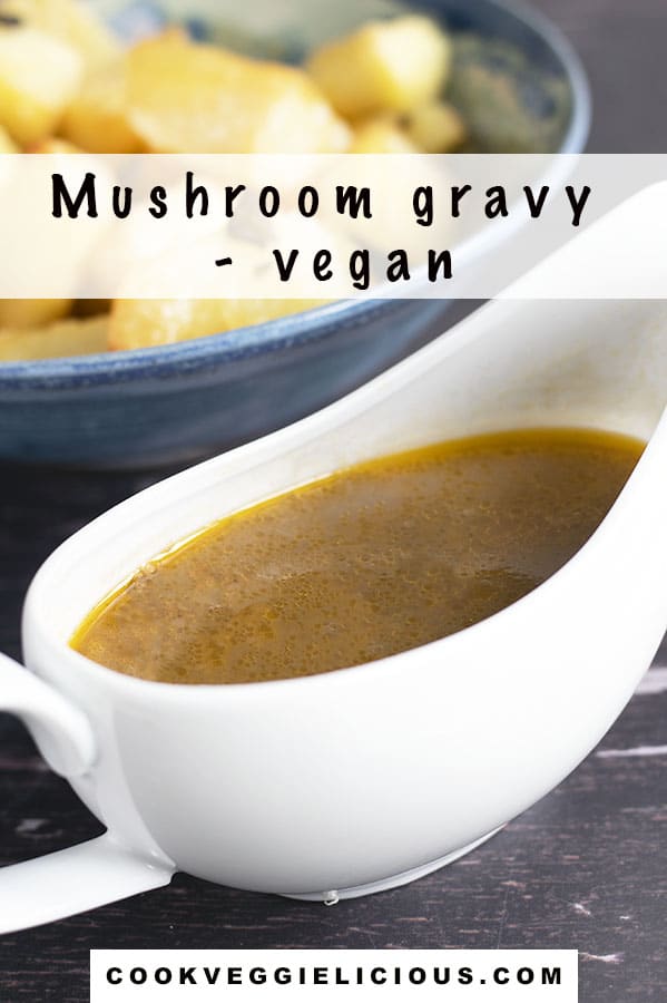 vegan mushroom gravy in white gravy boat with roast potatoes in background