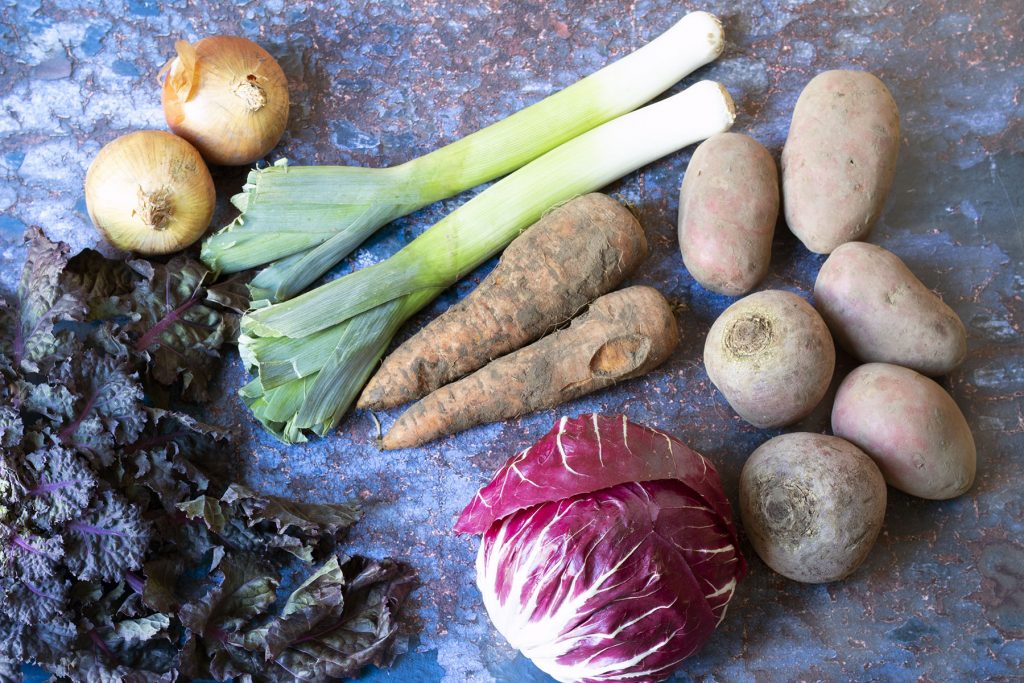 february seasonal vegetables - sprout tops, onions, leeks, carrots, potatoes, radicchio