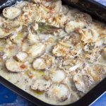 Jerusalem artichoke gratin in black roasting tin