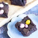 vegan mini egg brownies on board and blue plate