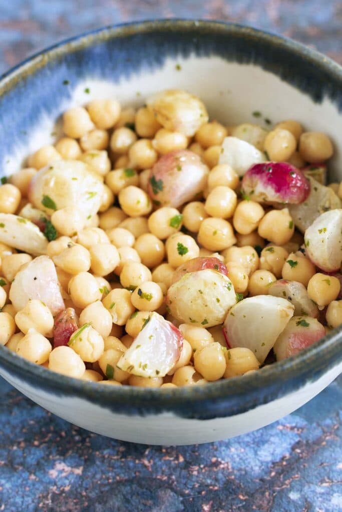 Radishes and chickpeas with herbs in bowl