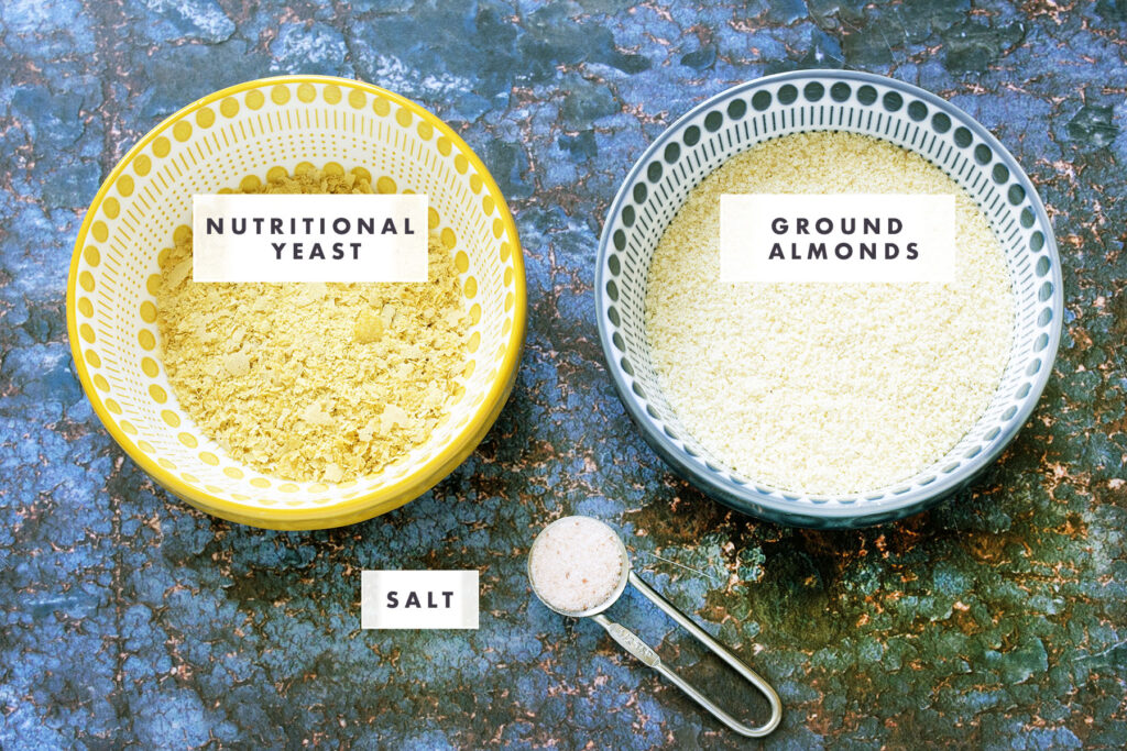 nutritional yeast, ground almonds, pink salt on blue background