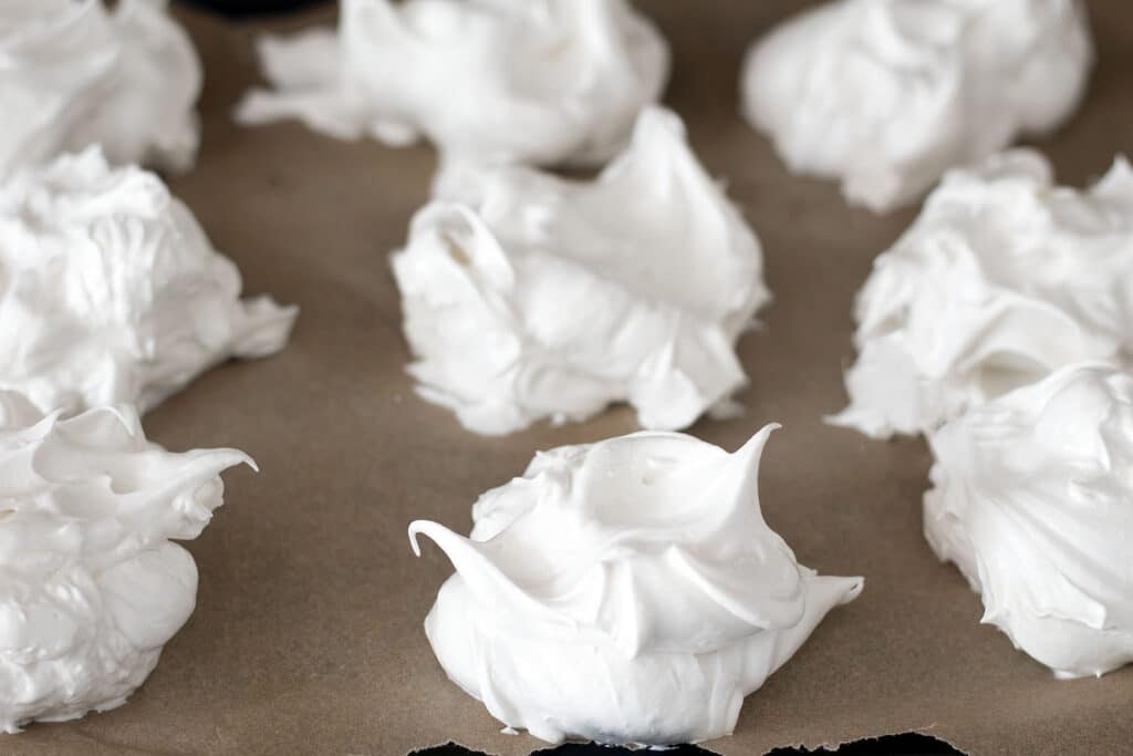 uncooked meringues on baking paper