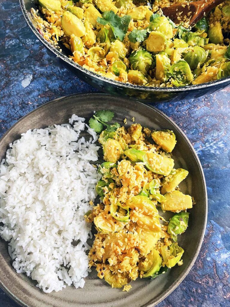 brussels sprouts and coconut curry with rice on ceramic plate