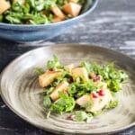 rocket, lemon and pomegranate salad on plate