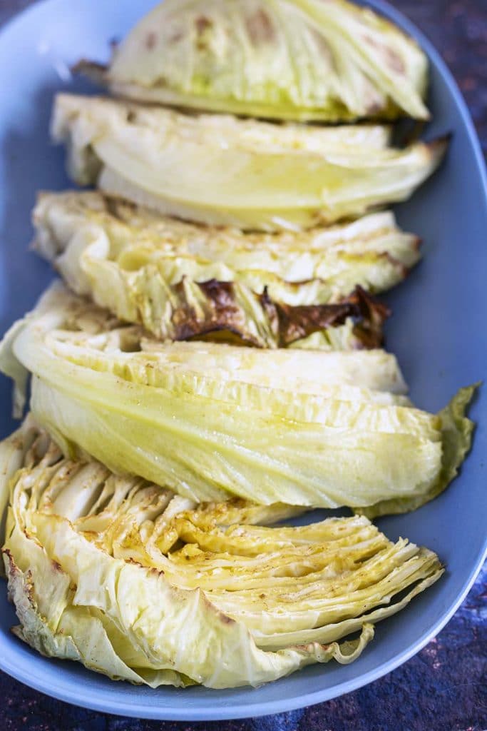 roasted cabbage wedges on blue platter