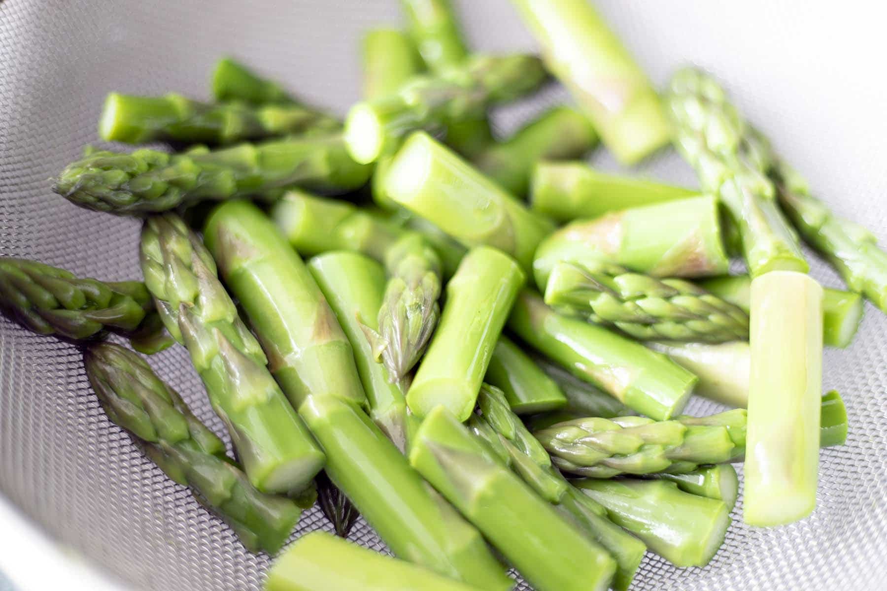 blanched asparagus in sieve