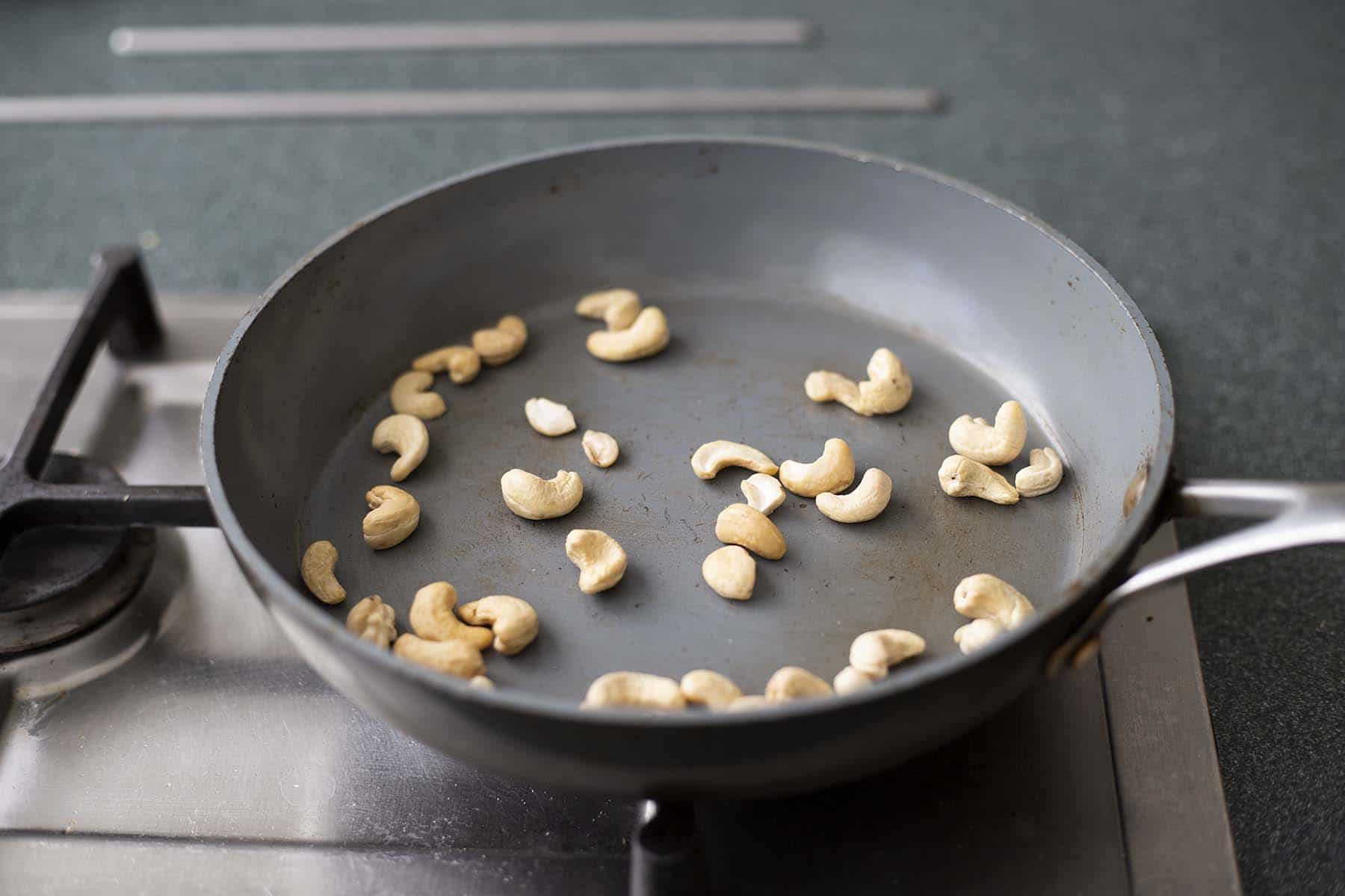 cashews toasting on frying pan