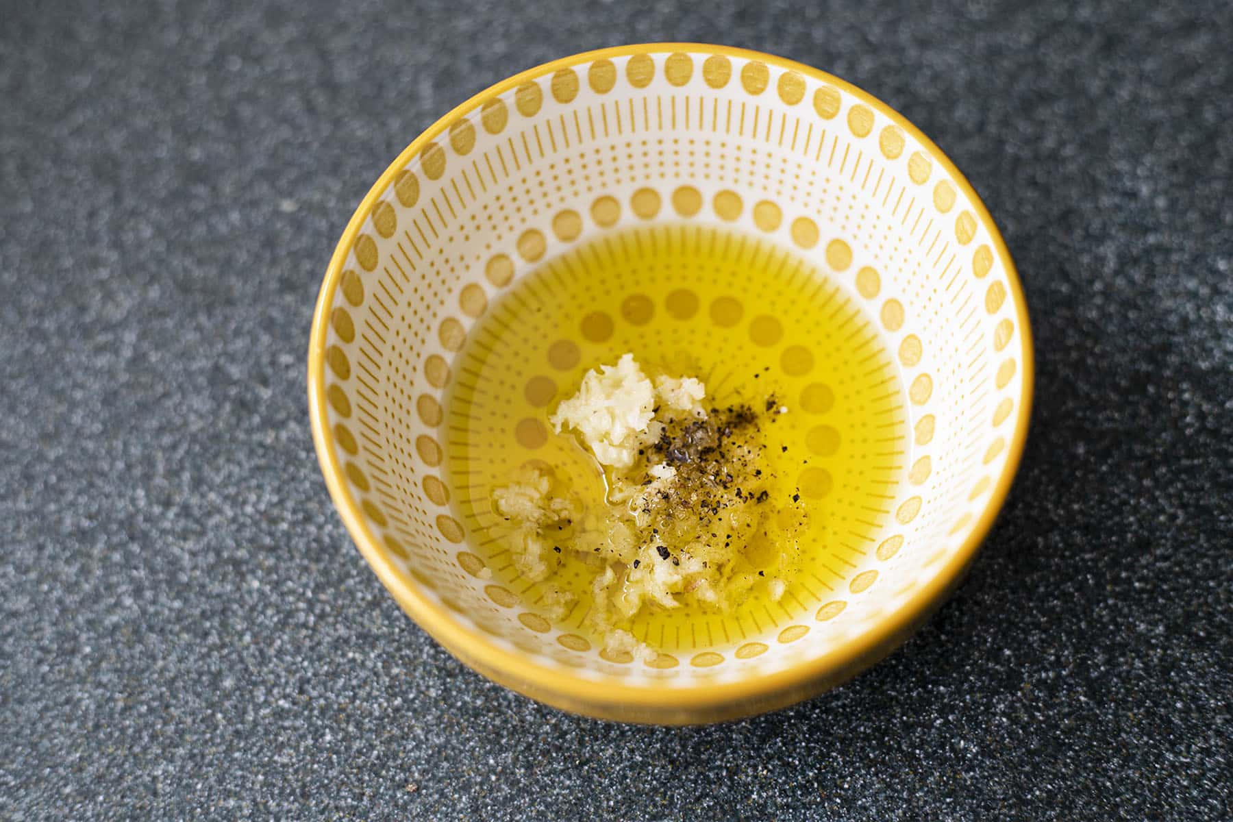 yellow and white bowl with olive oil and garlic