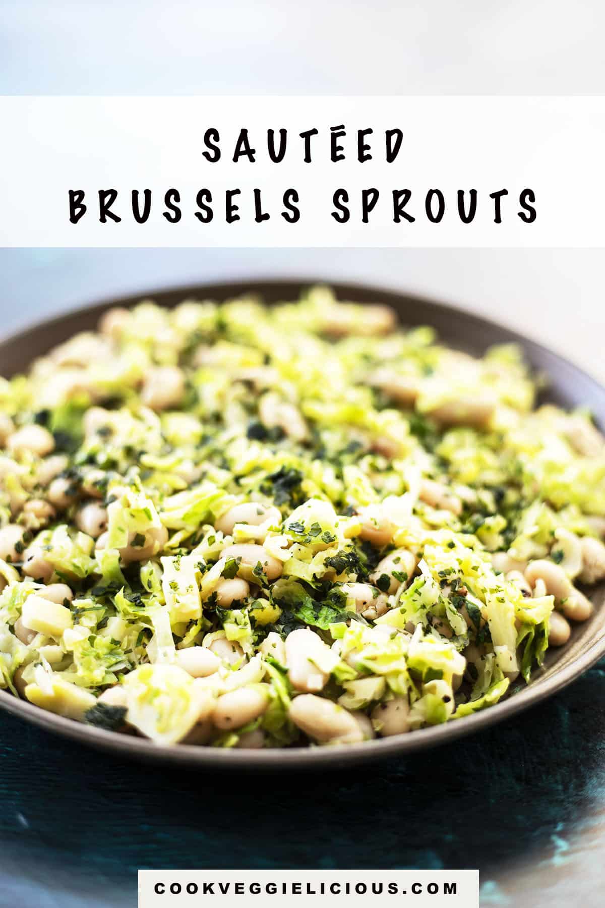 sautéed brussels sprouts with white beans on a ceramic plate